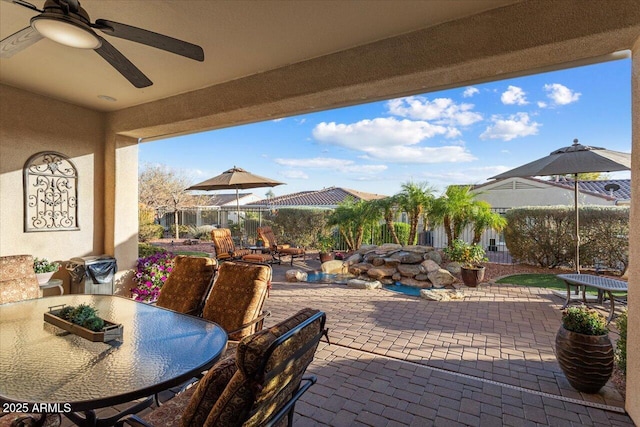 view of patio / terrace featuring outdoor dining area and ceiling fan