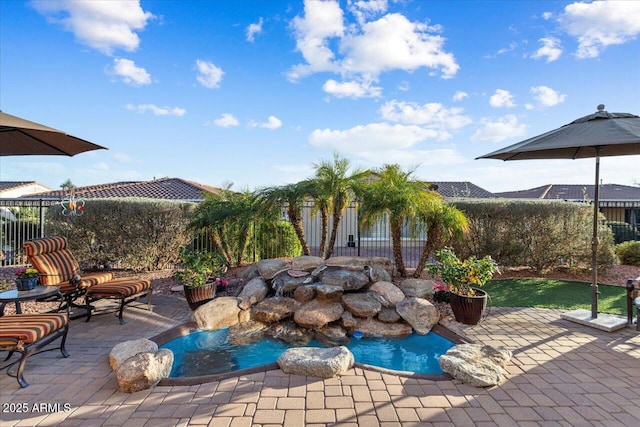 view of pool featuring a patio and fence