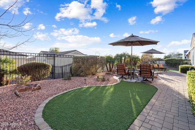 view of yard with fence and a patio