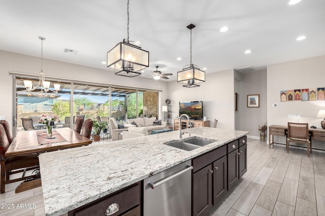 kitchen with a sink, a chandelier, dishwasher, open floor plan, and recessed lighting