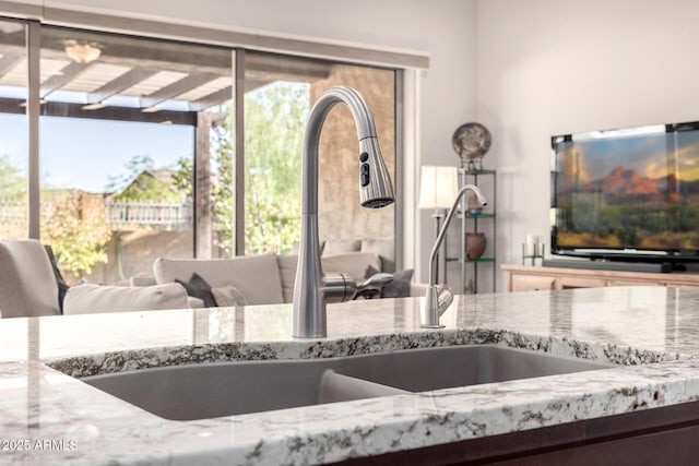 detailed view of light stone counters and a sink