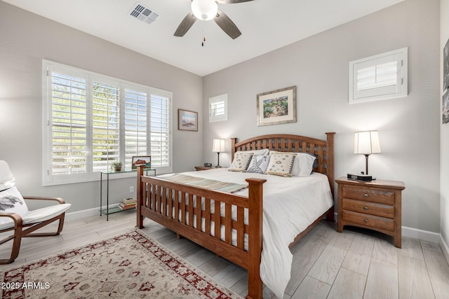 bedroom with baseboards, light wood-style floors, and a ceiling fan