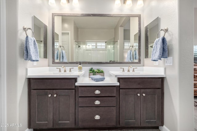 full bath with a shower stall and vanity