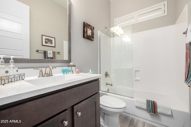 bathroom featuring toilet, vanity, and shower / bathtub combination