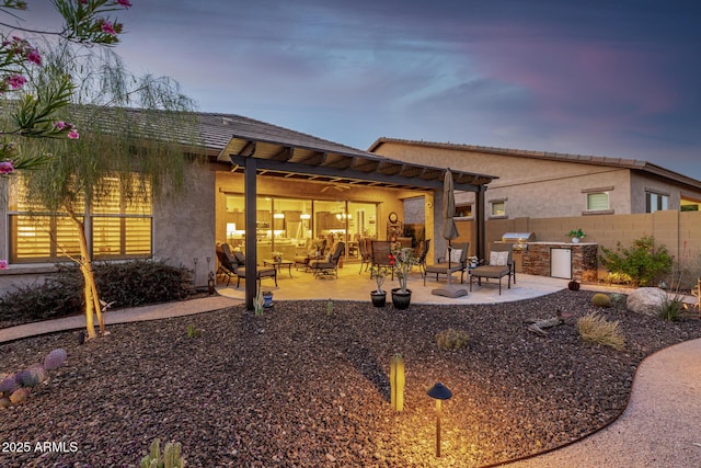 back of property with area for grilling, a patio, stucco siding, and a pergola
