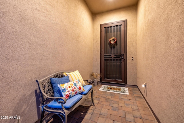 view of exterior entry featuring stucco siding
