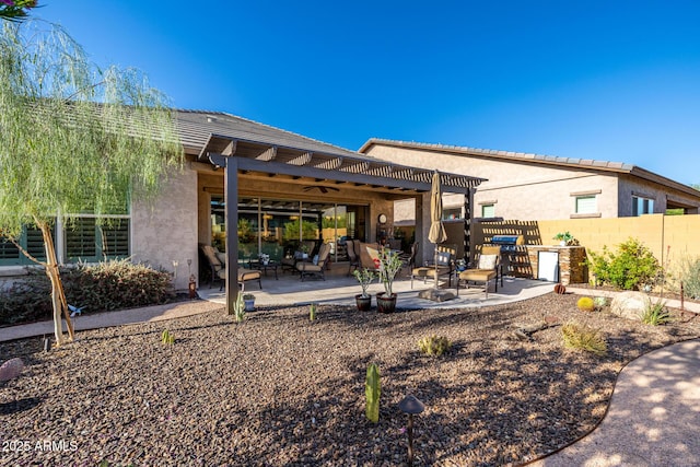 back of house featuring a pergola, stucco siding, and a patio