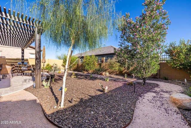 fenced backyard with a pergola and a patio