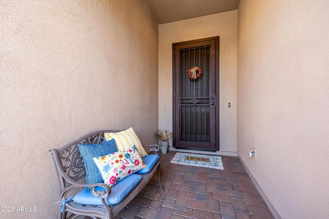 view of exterior entry with stucco siding