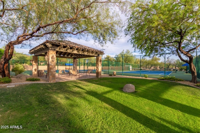 view of property's community with a tennis court and a gazebo