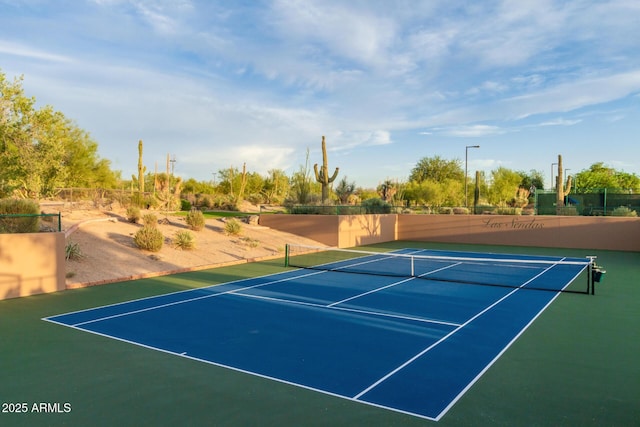 view of tennis court featuring community basketball court
