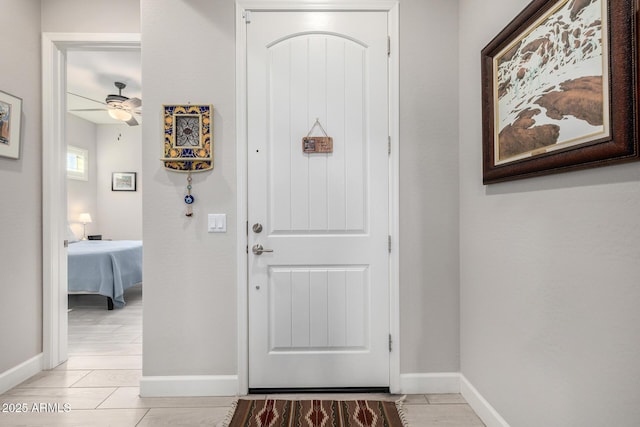 entrance foyer with baseboards and a ceiling fan