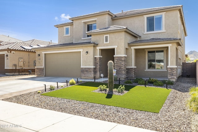 view of front of property featuring a front yard and a garage