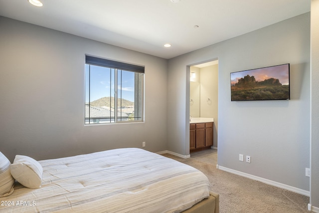 carpeted bedroom with ensuite bathroom