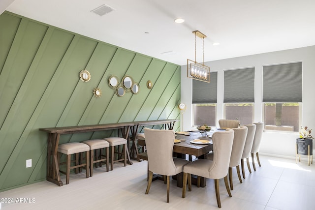 dining room with wood walls