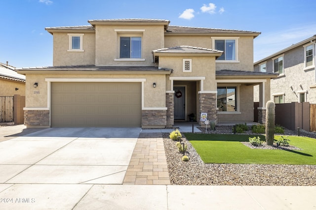 view of front of property featuring a garage and a front yard