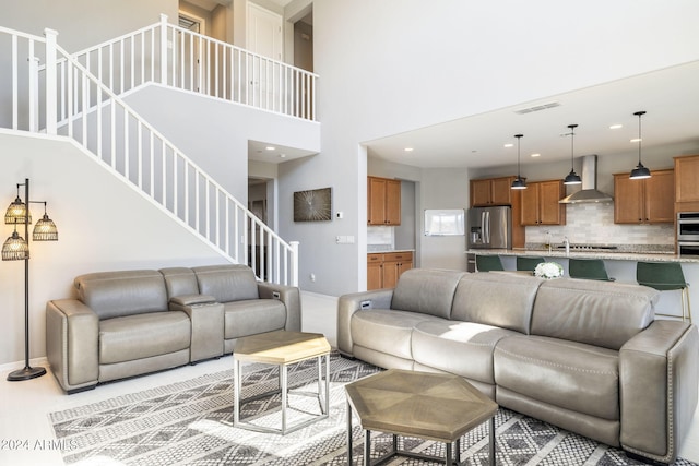 living room featuring light tile patterned floors and a towering ceiling