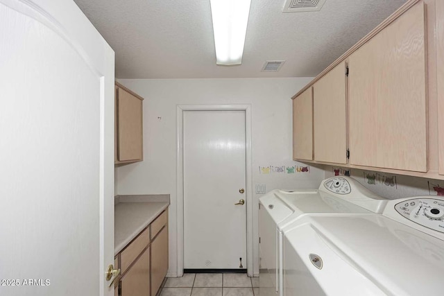 4081 N 156th Dr, Goodyear, AZ 85395 - laundry area with cabinet space, independent washer and dryer, light tile patterned flooring, and a textured ceiling