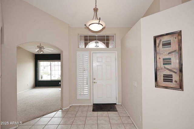 4081 N 156th Dr, Goodyear, AZ 85395 - entryway featuring arched walkways, baseboards, a ceiling fan, light tile patterned floors, and light carpet