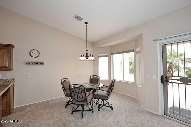 4081 N 156th Dr, Goodyear, AZ 85395 - dining space featuring light colored carpet, a chandelier, baseboards, and vaulted ceiling