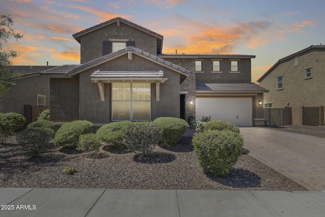 11875 W Lone Tree Trl, Peoria, AZ 85383 - traditional-style house featuring decorative driveway, stucco siding, an attached garage, and a tile roof