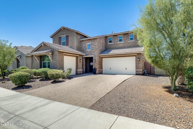 11875 W Lone Tree Trl, Peoria, AZ 85383 - traditional home featuring decorative driveway, stucco siding, stone siding, an attached garage, and a tiled roof