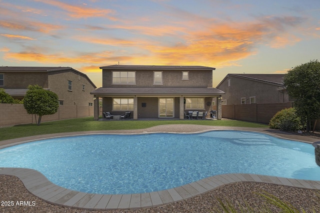 11875 W Lone Tree Trl, Peoria, AZ 85383 - pool at dusk with a patio and an outdoor hangout area
