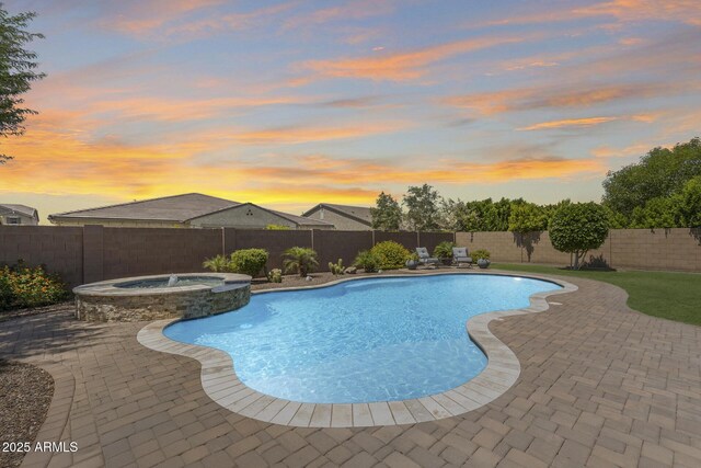 11875 W Lone Tree Trl, Peoria, AZ 85383 - pool at dusk with a fenced backyard, a patio, and a pool with connected hot tub