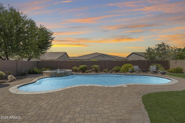 11875 W Lone Tree Trl, Peoria, AZ 85383 - pool at dusk with a fenced backyard, a patio, and a pool with connected hot tub