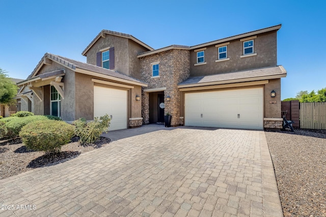 11875 W Lone Tree Trl, Peoria, AZ 85383 - view of front of house with stone siding, stucco siding, driveway, and an attached garage