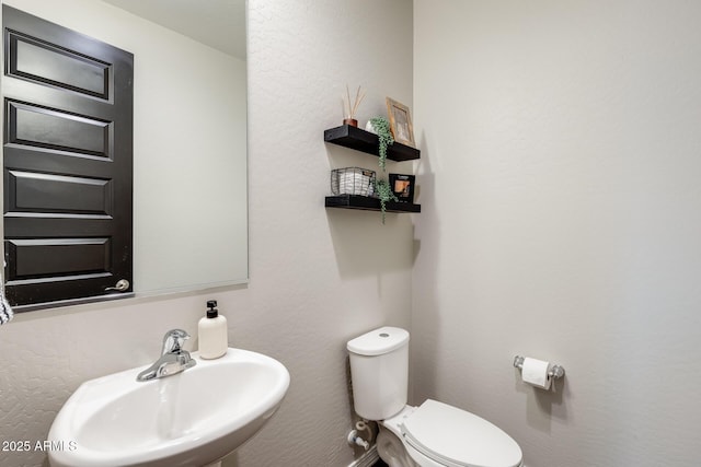11875 W Lone Tree Trl, Peoria, AZ 85383 - half bathroom featuring a sink and toilet