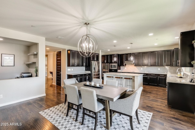 11875 W Lone Tree Trl, Peoria, AZ 85383 - dining room with a chandelier, dark wood-style flooring, recessed lighting, and baseboards