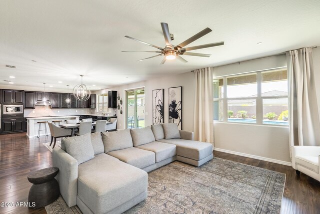 11875 W Lone Tree Trl, Peoria, AZ 85383 - living area with ceiling fan, recessed lighting, dark wood-style flooring, a chandelier, and baseboards