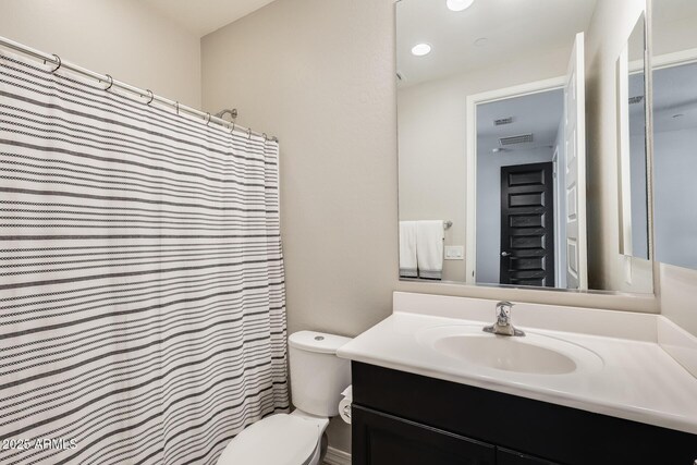 11875 W Lone Tree Trl, Peoria, AZ 85383 - bathroom with vanity, toilet, a shower with shower curtain, and recessed lighting