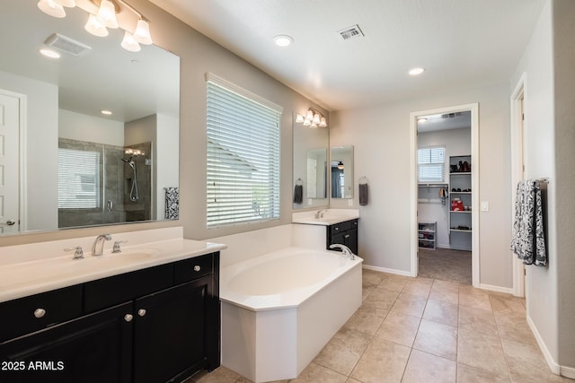 11875 W Lone Tree Trl, Peoria, AZ 85383 - full bathroom featuring a stall shower, healthy amount of natural light, vanity, a spacious closet, and recessed lighting