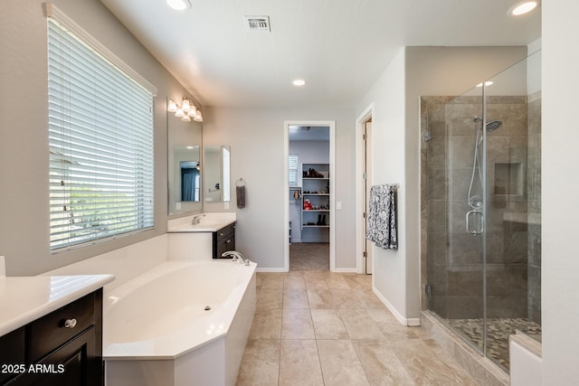 11875 W Lone Tree Trl, Peoria, AZ 85383 - bathroom featuring a shower stall, vanity, a garden tub, recessed lighting, and baseboards
