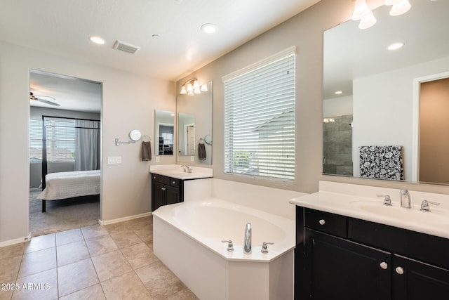 11875 W Lone Tree Trl, Peoria, AZ 85383 - ensuite bathroom featuring two vanities, a garden tub, tile patterned floors, recessed lighting, and a ceiling fan