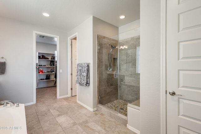 11875 W Lone Tree Trl, Peoria, AZ 85383 - full bathroom featuring a stall shower, a walk in closet, a garden tub, baseboards, and recessed lighting
