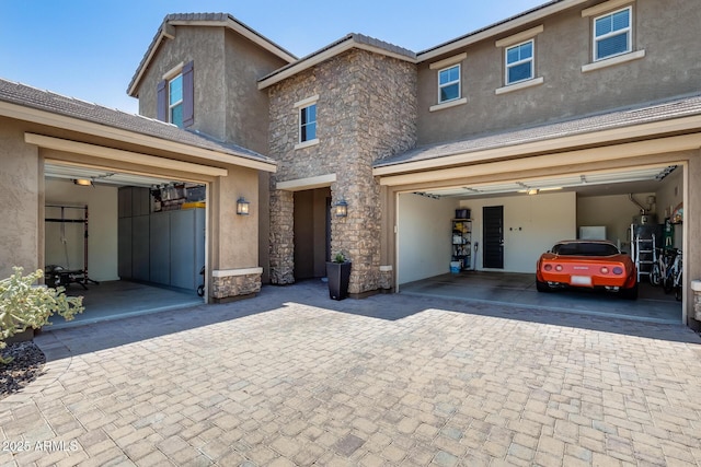 11875 W Lone Tree Trl, Peoria, AZ 85383 - view of front of house featuring stone siding, stucco siding, and decorative driveway