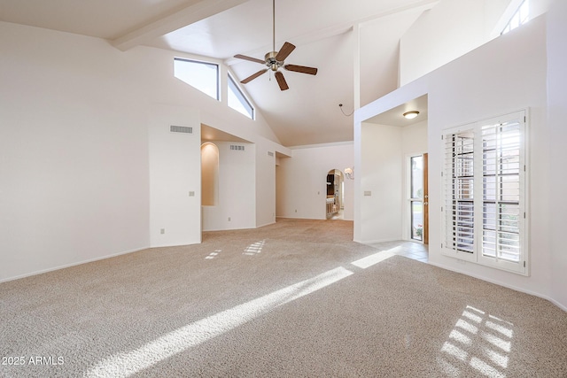 empty room with ceiling fan, light colored carpet, high vaulted ceiling, and beamed ceiling