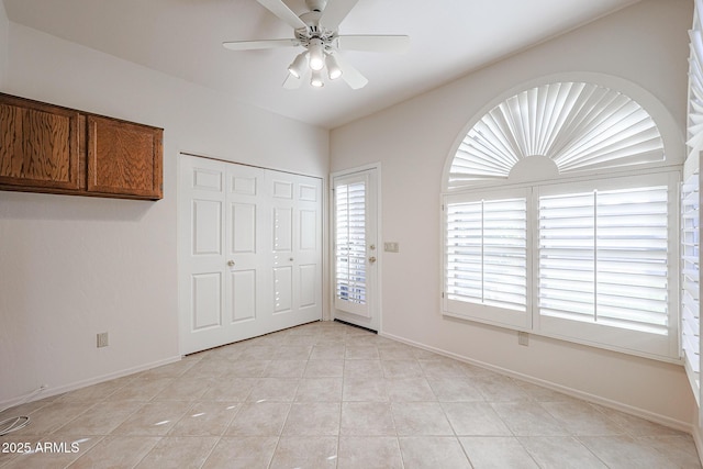 interior space featuring ceiling fan and light tile patterned floors