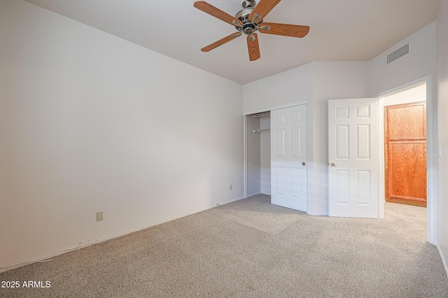 unfurnished bedroom featuring light carpet, ceiling fan, and a closet