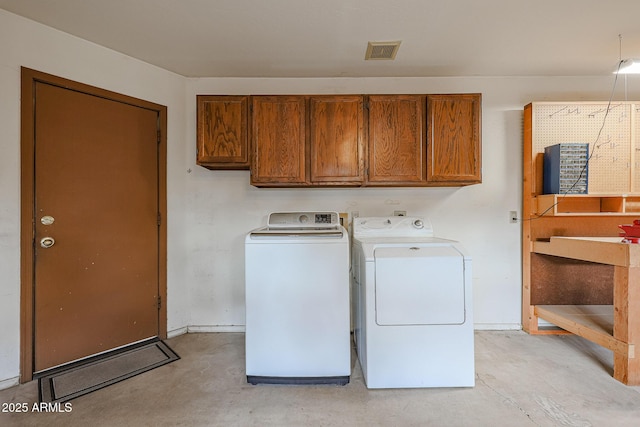 laundry room with cabinets and washer and dryer