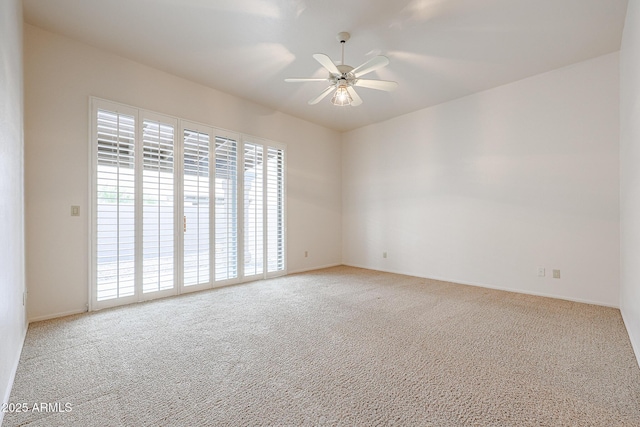 unfurnished room with light colored carpet and ceiling fan