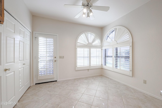 interior space featuring light tile patterned flooring and ceiling fan