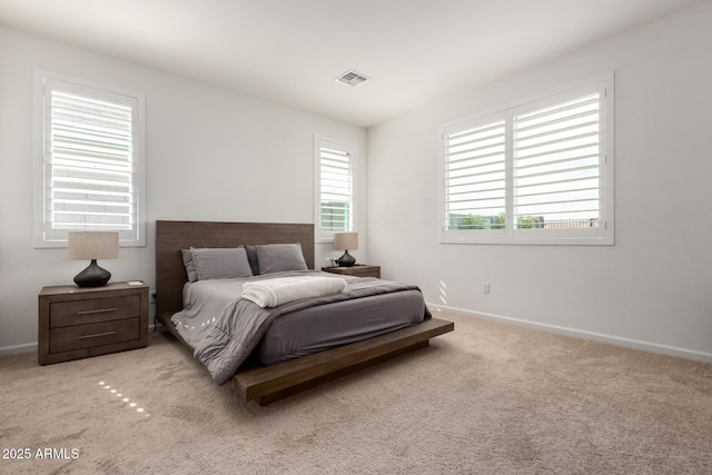 carpeted bedroom with baseboards and visible vents