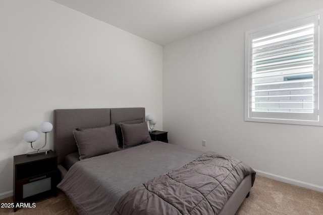carpeted bedroom with baseboards and multiple windows