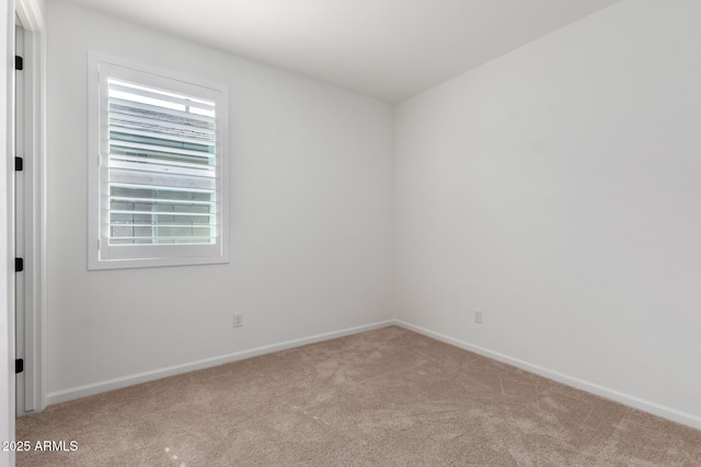carpeted spare room with baseboards