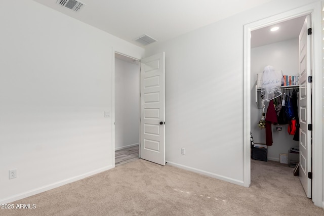 carpeted bedroom featuring baseboards, visible vents, a spacious closet, and a closet