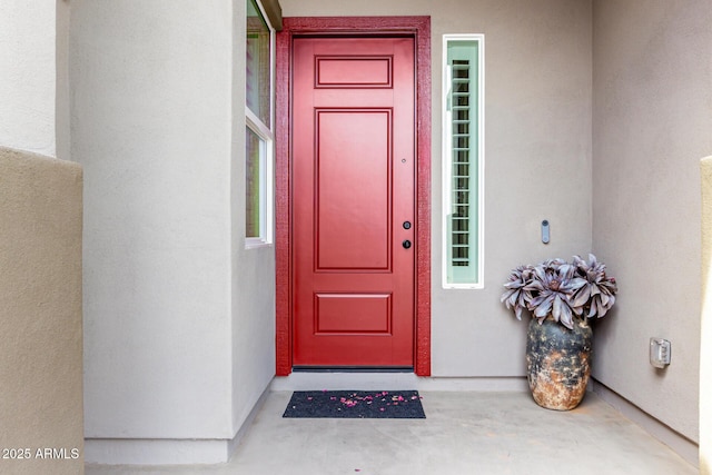 entrance to property featuring stucco siding